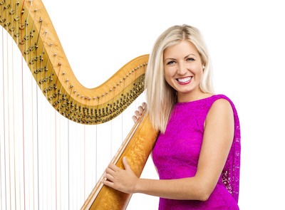 female harpist stood with her full-size  harp